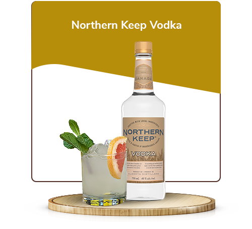 Northern Keep Vodka, and a garnished cocktail made with it in a glass. They both sit on top of a small wooden pedestal.